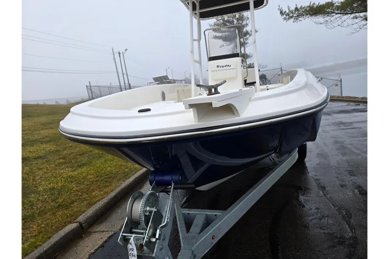 Slide: The Image of 2022 Bayliner Trophy T21Bay boat on trailer, parked on a foggy day. - 6