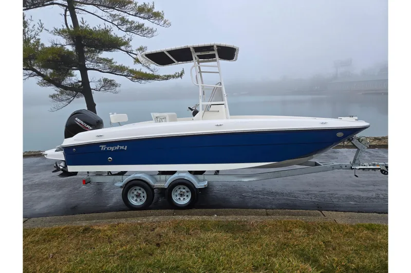 Slide: The Image of 2022 Bayliner Trophy T21Bay boat on trailer by a foggy lake. - 9