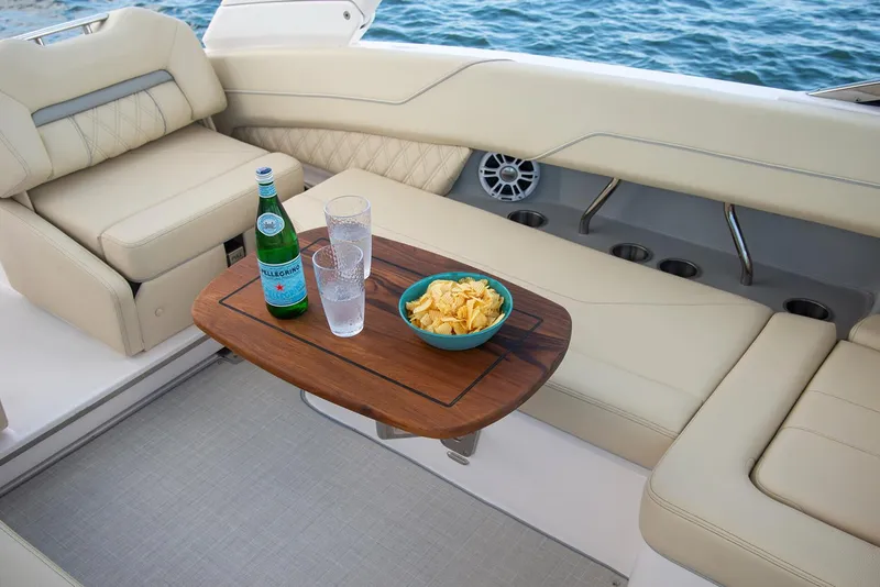 Slide: The Image of Luxurious 2025 Regal LX6 boat interior with ambient red lighting and sleek seating design. - 11