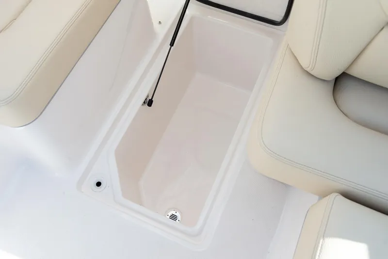 Slide: The Image of 2025 Regal LX6 boat interior with modern seating, cup holders, and ambient lighting. - 14