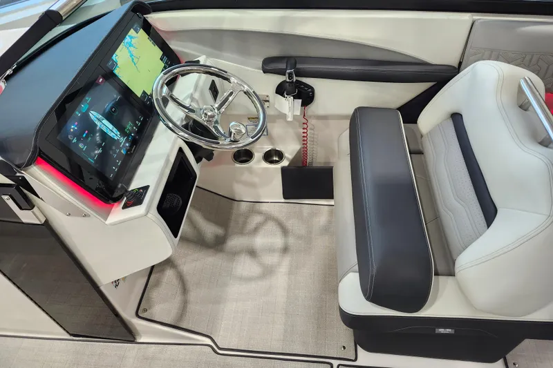 Slide: The Image of 2025 Regal LX6 boat cockpit with modern steering and digital display. - 22