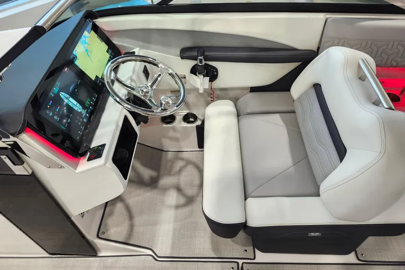 Slide: The Image of 2025 Regal LX6 boat interior with modern dashboard, touchscreen display, and luxurious seating. - 23