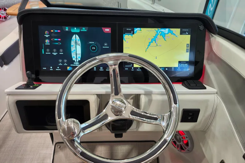 Slide: The Image of 2025 Regal LX6 boat dashboard with dual touchscreens and modern steering wheel. - 24