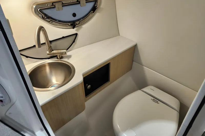 Slide: The Image of 2025 Regal LX6 boat bathroom with stainless steel sink and modern toilet. - 28