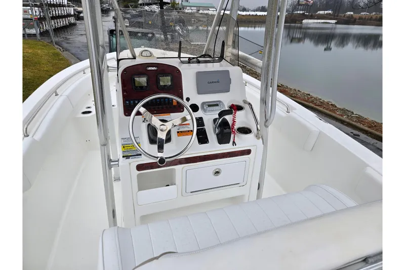 Slide: The Image of 2012 Sea Hunt Ultra 234 boat console with steering wheel and Garmin navigation system. - 11