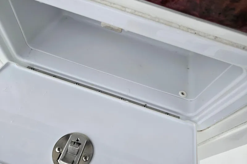 Slide: The Image of Open storage compartment on a 2012 Sea Hunt Ultra 234 boat. - 14