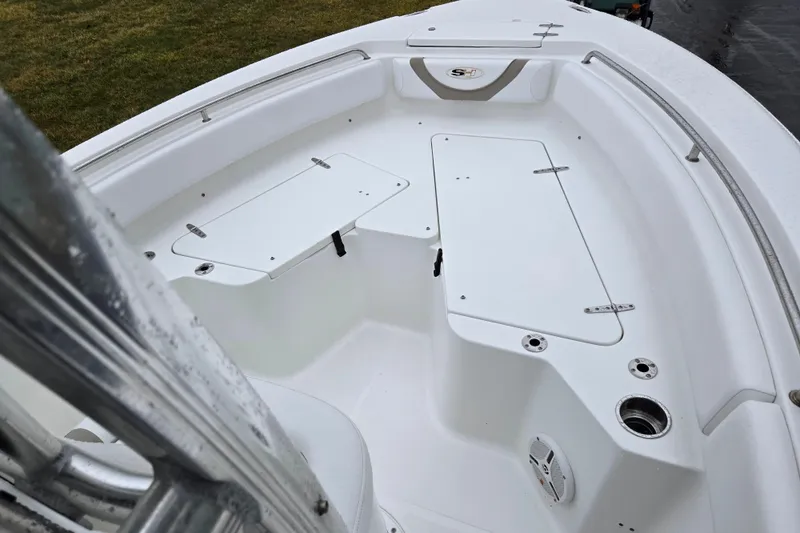 Slide: The Image of 2012 Sea Hunt Ultra 234 boat interior with storage compartments and seating area. - 15