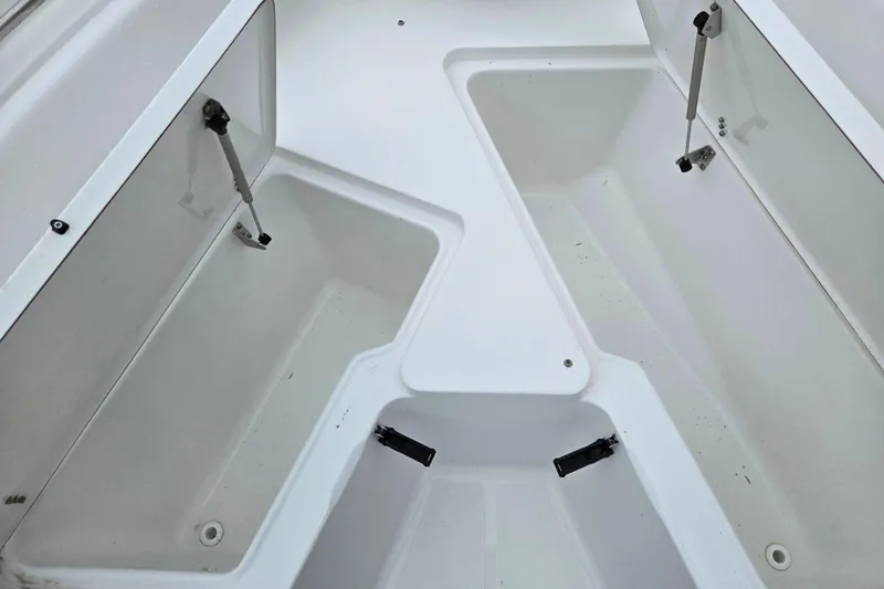 Slide: The Image of Open storage compartments on a 2012 Sea Hunt Ultra 234 boat deck. - 17