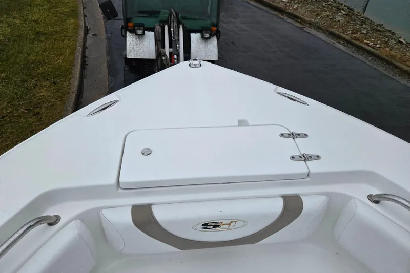 Slide: The Image of Bow view of 2012 Sea Hunt Ultra 234 boat on trailer near water. - 18