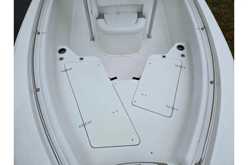 Slide: The Image of 2012 Sea Hunt Ultra 234 boat interior with storage compartments and seating. - 19