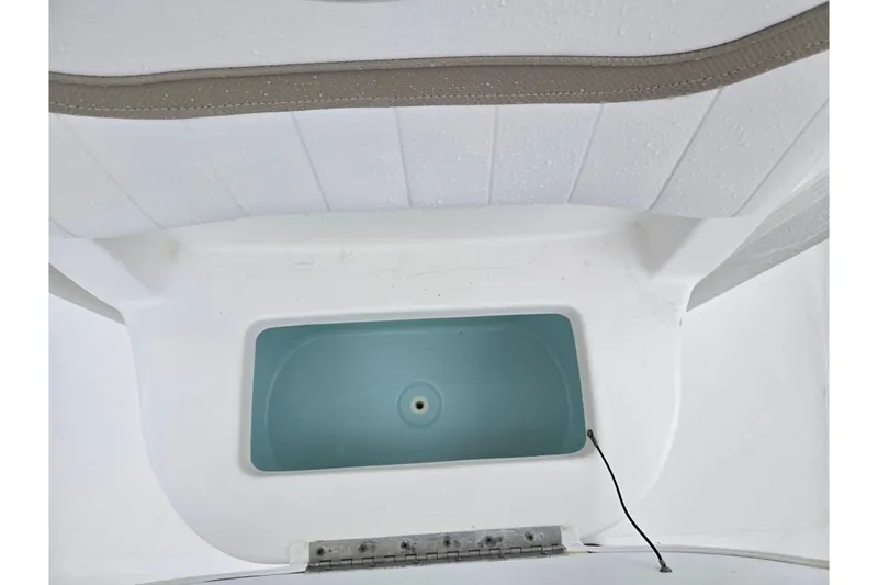 Slide: The Image of Livewell compartment on a 2012 Sea Hunt Ultra 234 boat, featuring a clean, white interior. - 21
