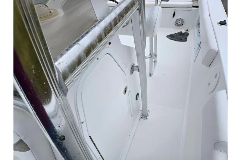 Slide: The Image of 2012 Sea Hunt Ultra 234 boat interior with white seating and metal railings. - 22