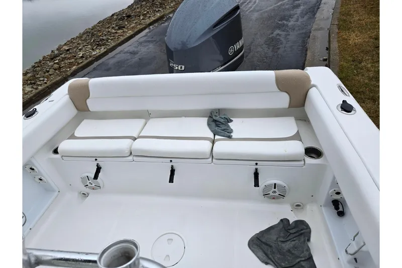 Slide: The Image of 2012 Sea Hunt Ultra 234 boat interior with seating and Yamaha engine. - 25