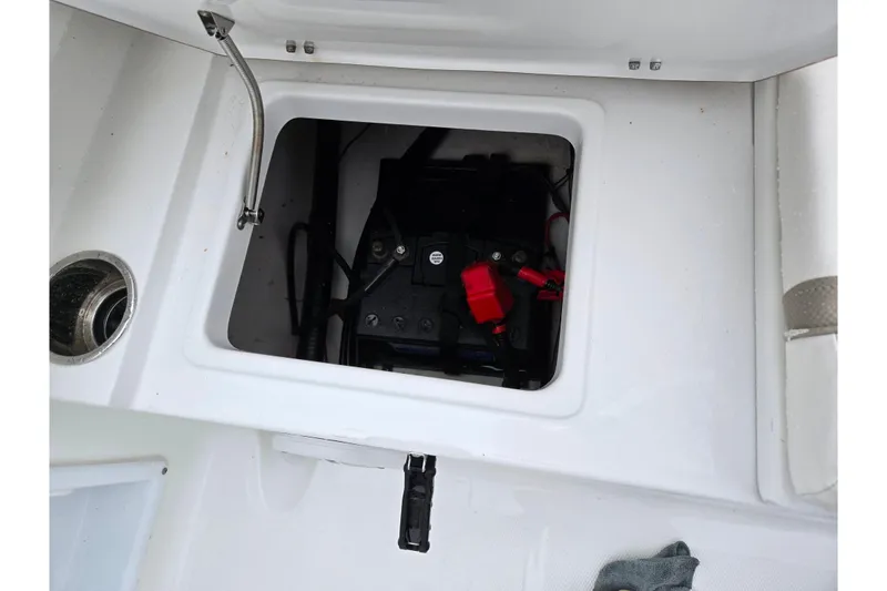 Slide: The Image of Battery compartment of 2012 Sea Hunt Ultra 234 boat, showing wiring and connections. - 27