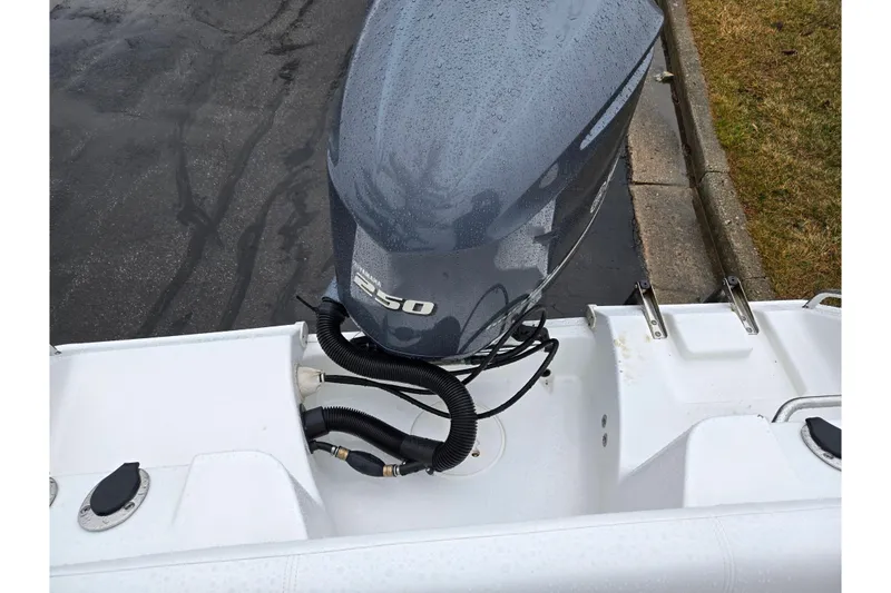 Slide: The Image of 2012 Sea Hunt Ultra 234 boat with Yamaha 250 outboard motor, wet surface. - 28