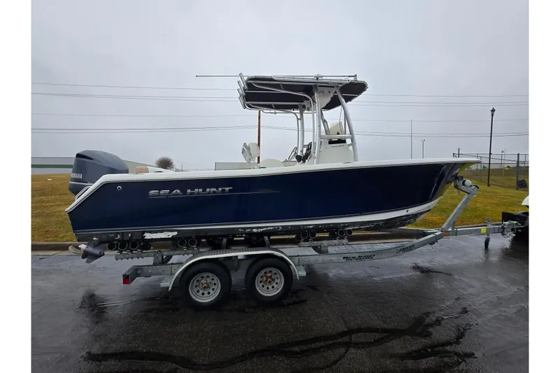 Slide: The Image of 2012 Sea Hunt Ultra 234 boat on trailer, side view, overcast day. - 4