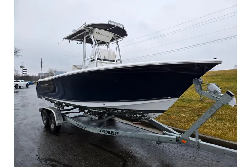 Slide: The Image of 2012 Sea Hunt Ultra 234 boat on trailer, parked on wet pavement. - 5