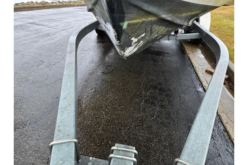 Slide: The Image of 2012 Sea Hunt Ultra 234 boat on trailer, parked on wet pavement. - 7