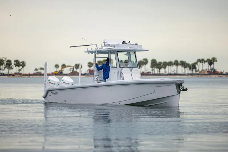 The Image of 2024 Dynamic D-305DF boat cruising on calm water with palm trees in the background. - 0