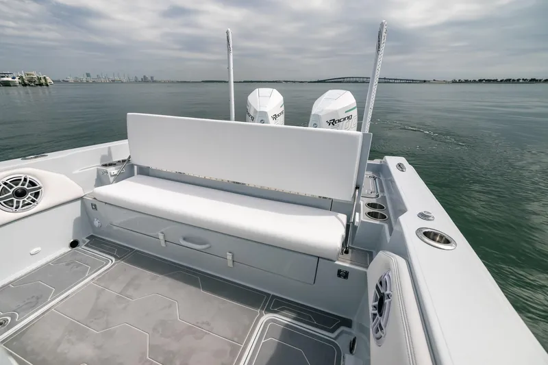 Slide: The Image of 2024 Dynamic D-305DF boat with dual engines, spacious seating, and sleek design on calm waters. - 13