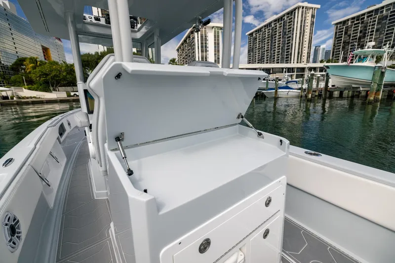 Slide: The Image of 2024 Dynamic D-305DF boat interior with open storage, docked near modern buildings. - 16