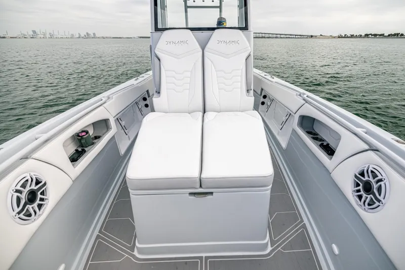 Slide: The Image of 2024 Dynamic D-305DF boat interior with white seating and ocean view. - 19