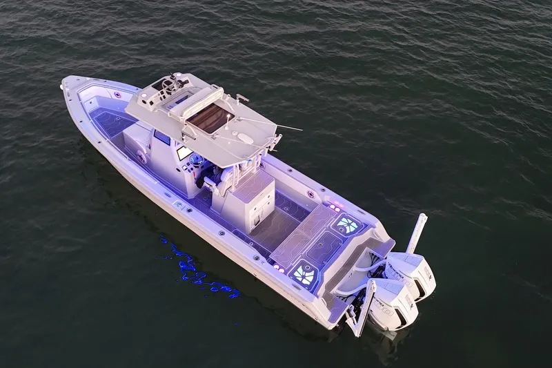Slide: The Image of Aerial view of 2024 Dynamic D-305DF boat on water, featuring modern design and dual engines. - 2