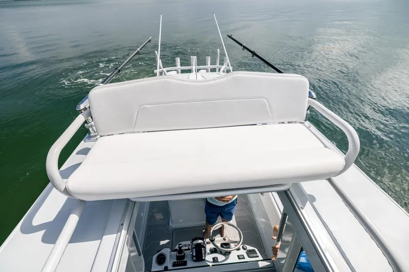 Slide: The Image of 2024 Dynamic D-305DF boat with white seating, navigating calm waters. - 24