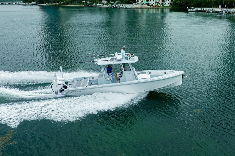 Slide: The Image of 2024 Dynamic D-305DF boat cruising on calm water, showcasing sleek design and performance. - 8