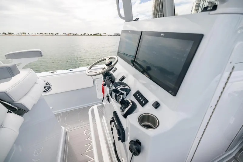 Slide: The Image of 2024 Dynamic D-305DF boat cockpit with dual screens and modern steering controls. - 9