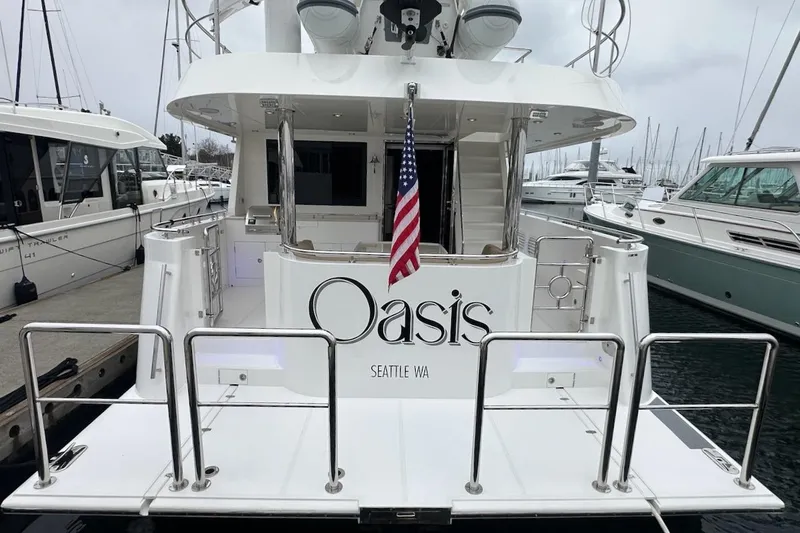 Slide: The Image of Luxury yacht "Oasis" docked, Northwest 55 model, 2024, Seattle WA, with American flag. - 11