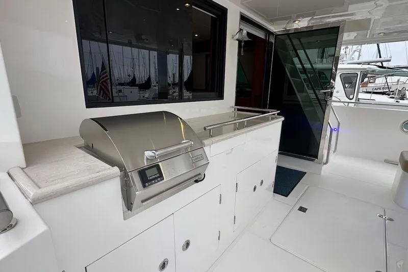 Slide: The Image of Outdoor kitchen area on a 2024 Northwest 55 yacht with stainless steel grill. - 17