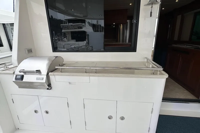Slide: The Image of Outdoor grill station on a 2024 Northwest 55 yacht, featuring storage cabinets and sleek design. - 18