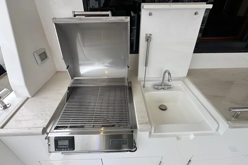 Slide: The Image of Outdoor kitchen with grill and sink on Northwest 55 yacht, 2024 model. - 19