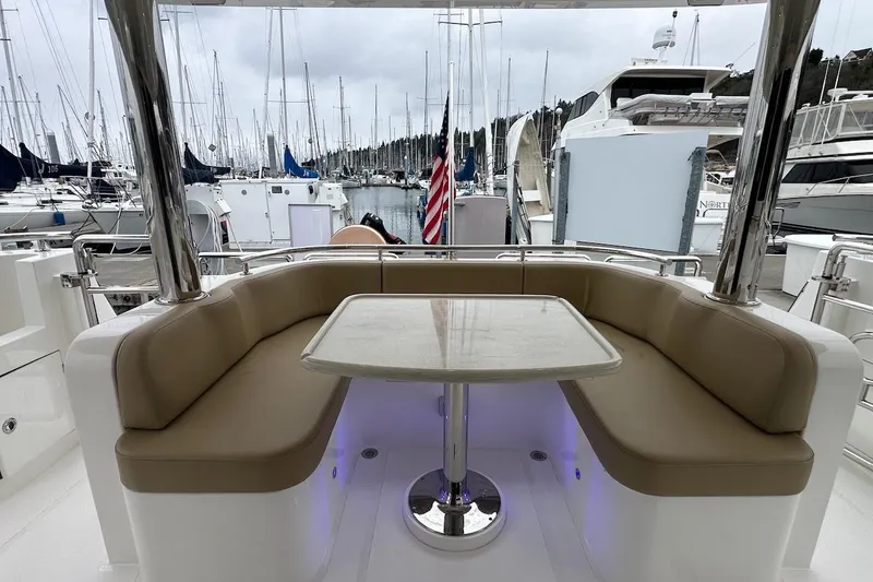 Slide: The Image of Luxurious seating area on 2024 Northwest 55 yacht, docked at marina with boats. - 21