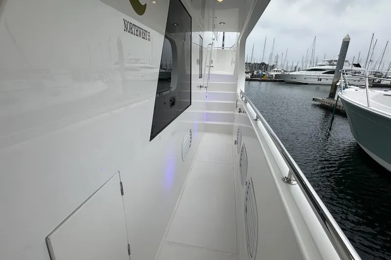 Slide: The Image of Sleek 2024 Northwest 55 yacht deck with marina view, showcasing modern design and luxury. - 23