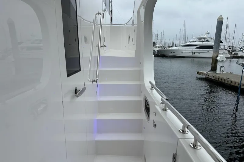 Slide: The Image of Staircase on a 2024 Northwest 55 yacht, docked at a marina. - 25