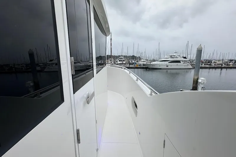 Slide: The Image of Side deck view of 2024 Northwest 55 yacht in marina with overcast sky. - 26