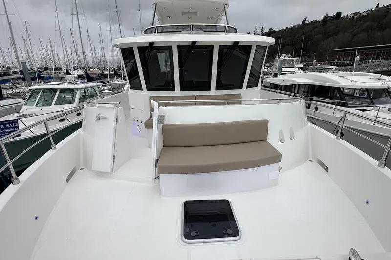 Slide: The Image of 2024 Northwest 55 yacht with spacious deck and seating at marina. - 29