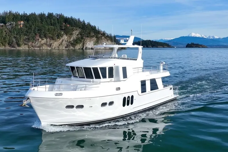 Slide: The Image of 2024 Northwest 55 yacht cruising on scenic waters with forested islands in the background. - 3