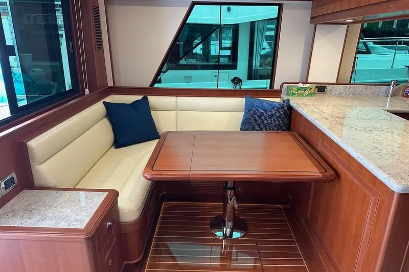 Slide: The Image of Luxurious interior of 2024 Northwest 55 yacht with elegant seating and wooden table. - 35
