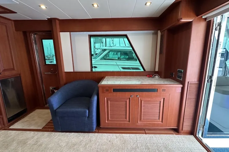 Slide: The Image of Luxurious interior of 2024 Northwest 55 yacht with wooden cabinetry and blue armchair. - 36