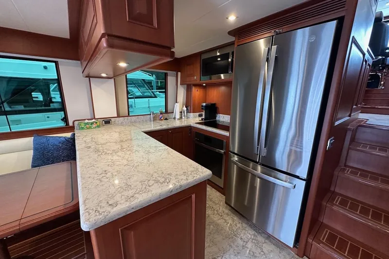 Slide: The Image of Luxurious kitchen interior of 2024 Northwest 55 yacht with modern appliances and elegant wood finish. - 38