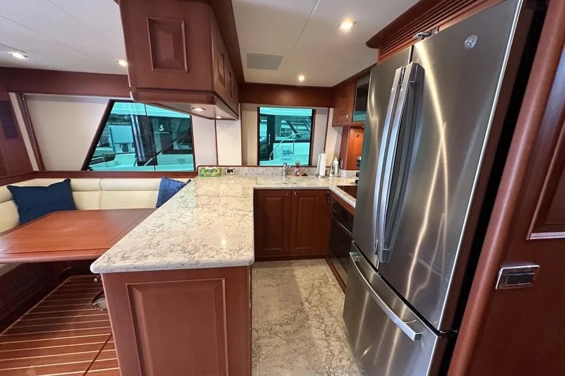 Slide: The Image of Luxurious kitchen interior of 2024 Northwest 55 yacht with modern appliances and elegant wood finish. - 39
