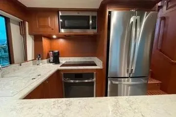 Slide: The Image of Modern kitchen in 2024 Northwest 55 model with stainless steel appliances and marble countertops. - 40