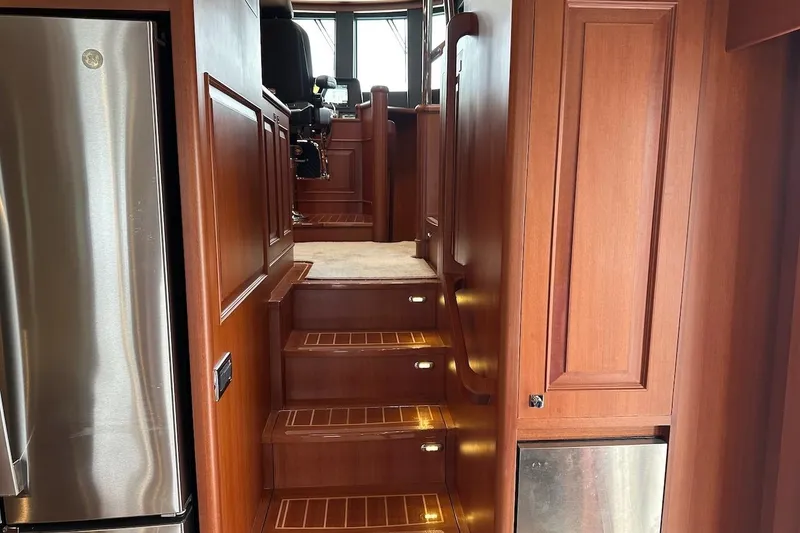 Slide: The Image of Luxurious wooden interior stairs in 2024 Northwest 55 yacht, featuring elegant cabinetry and lighting. - 42