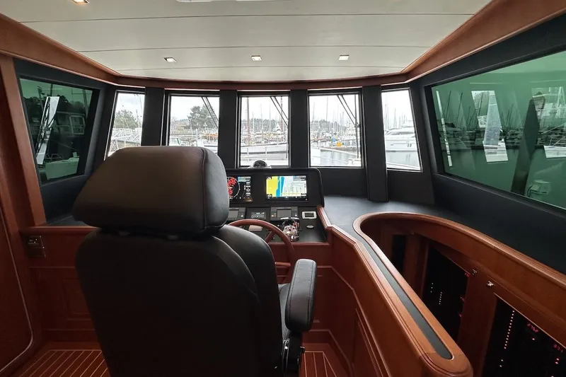 Slide: The Image of Pilothouse interior of 2024 Northwest 55 yacht, featuring modern navigation equipment and panoramic windows. - 44