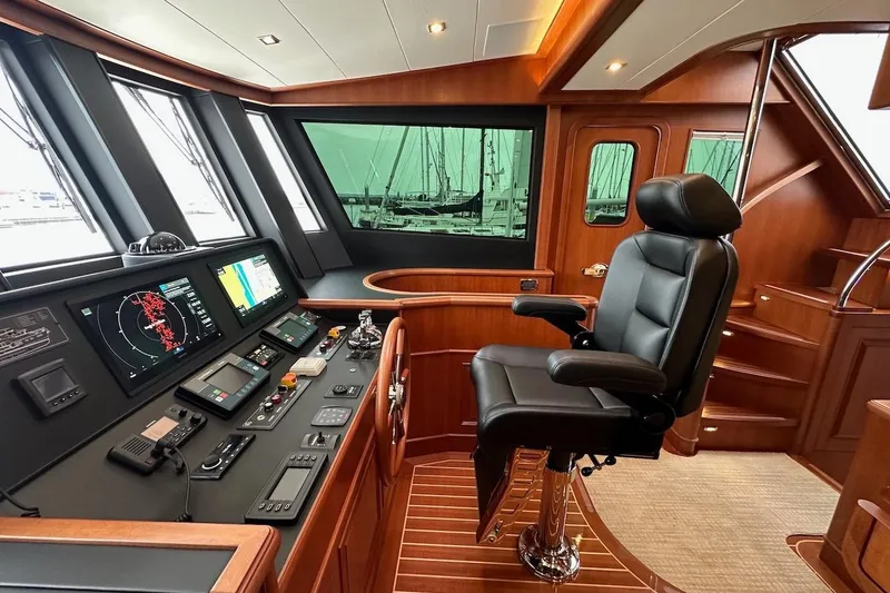 Slide: The Image of Luxurious 2024 Northwest 55 yacht helm with advanced navigation controls and plush captain's chair. - 45