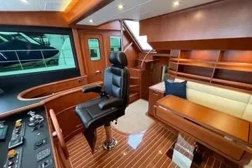 Slide: The Image of Luxurious interior of 2024 Northwest 55 yacht with leather chair and wooden furnishings. - 46