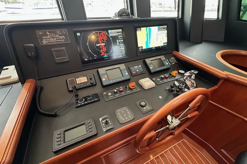 Slide: The Image of Cockpit of 2024 Northwest 55 yacht with advanced navigation controls and wooden steering wheel. - 47